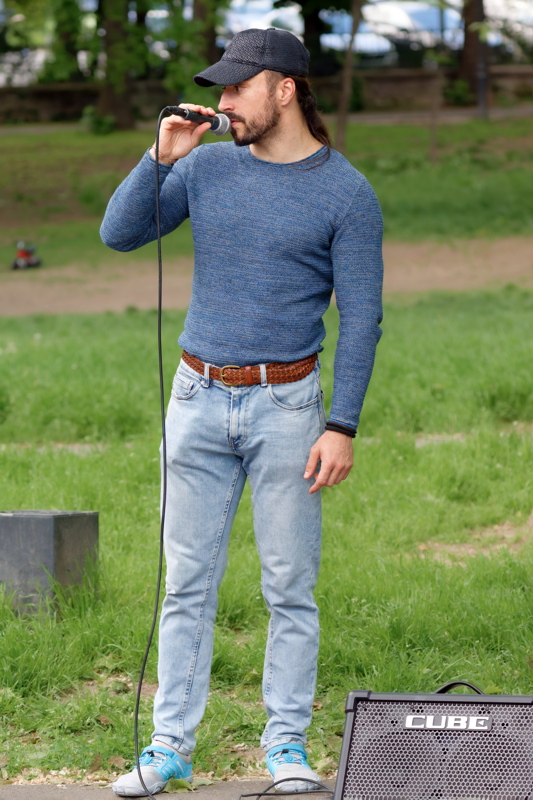 Young man singing with a microphone and speaker